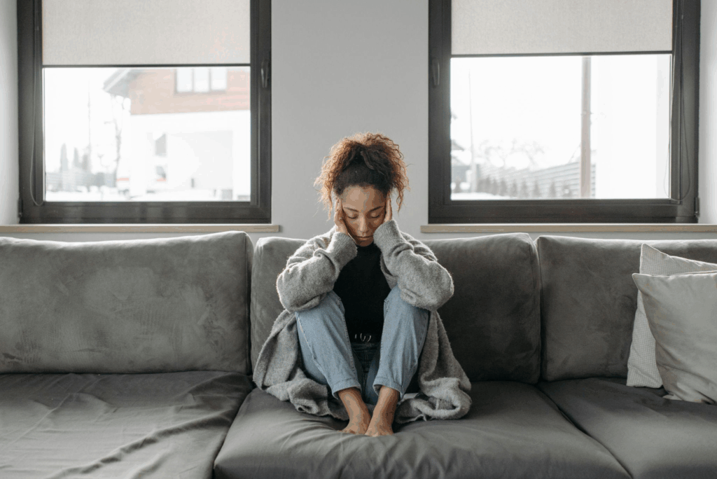 a woman holding her head due to a headache