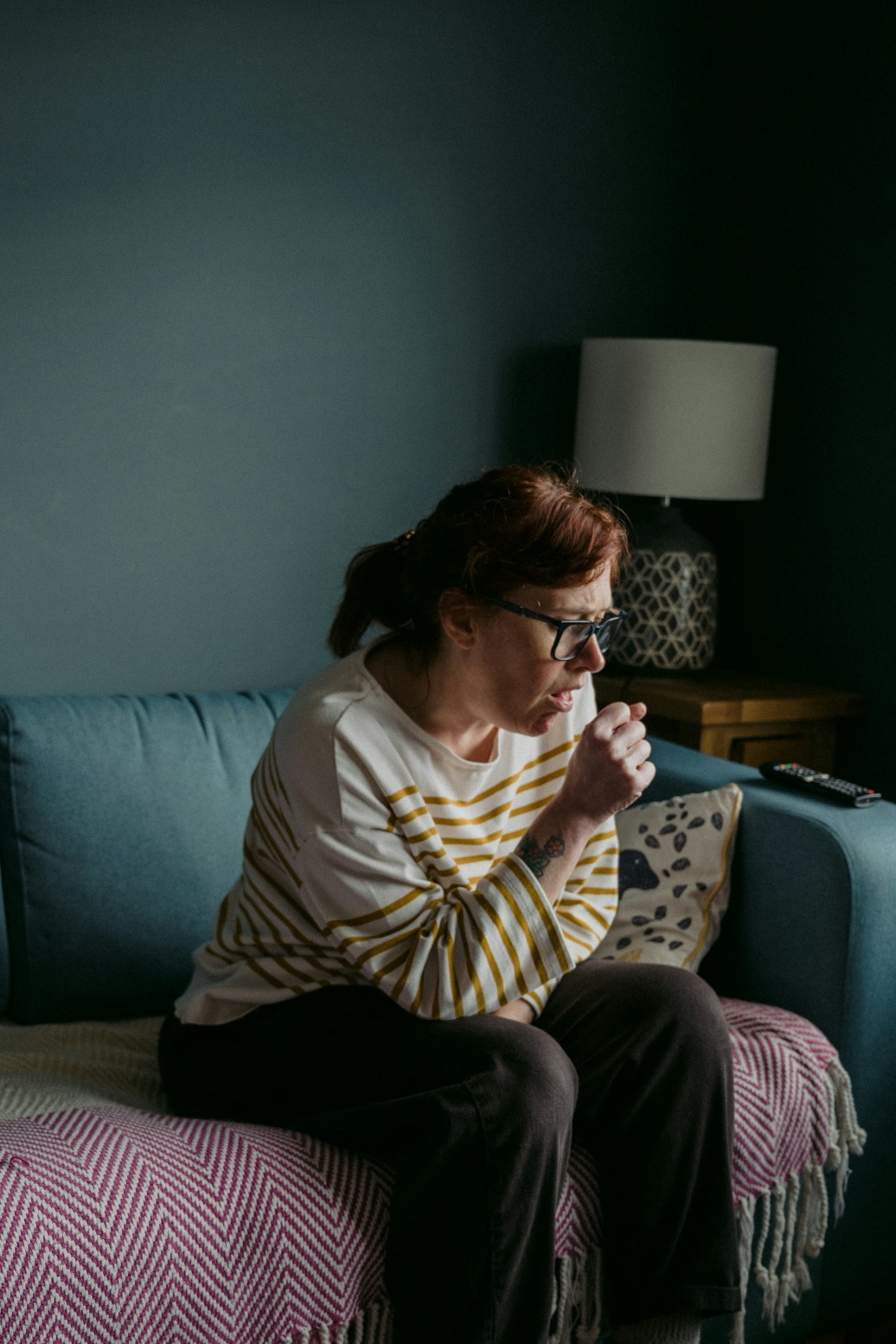 Woman coughing on couch