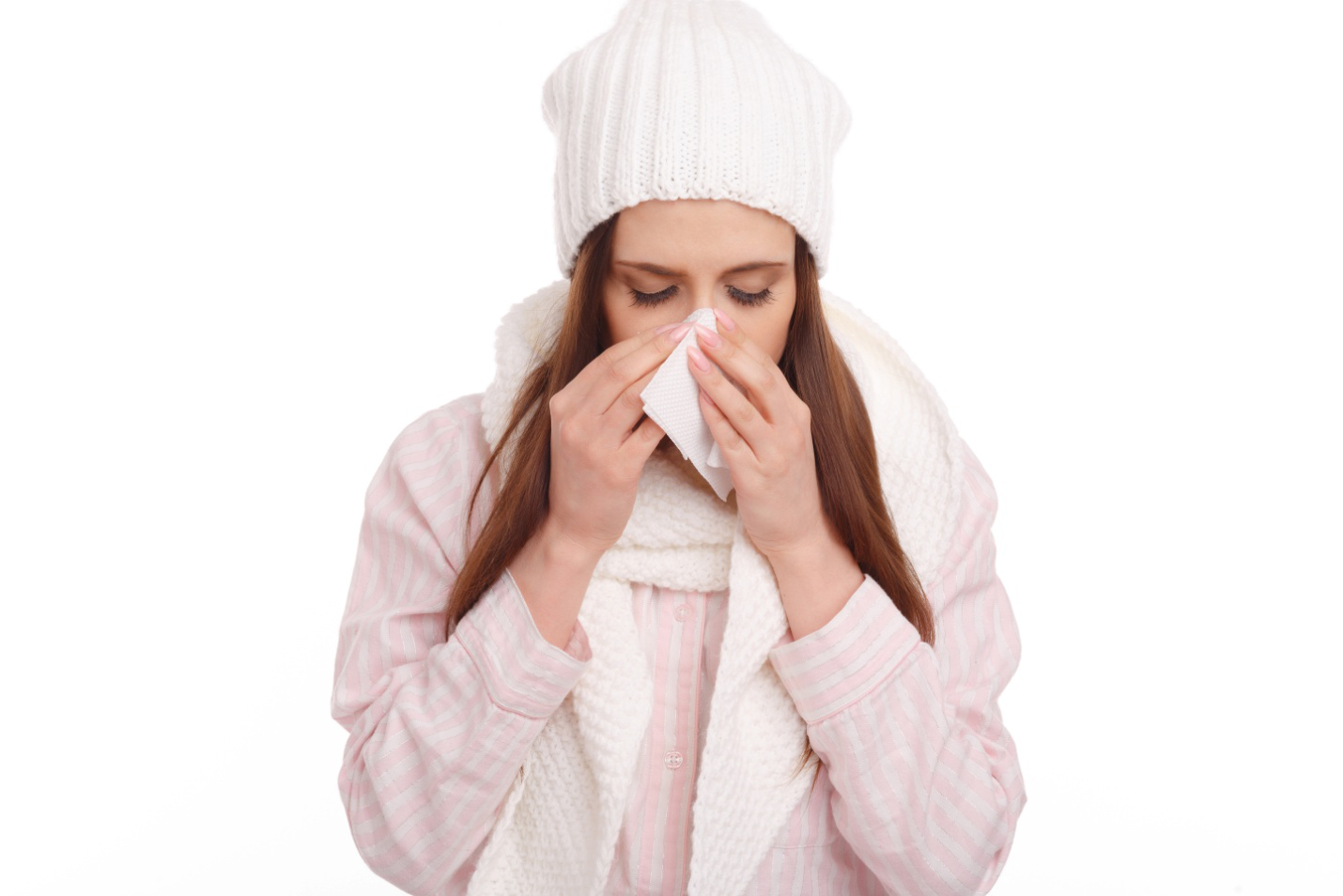 woman with tissue in her hand, sneezing