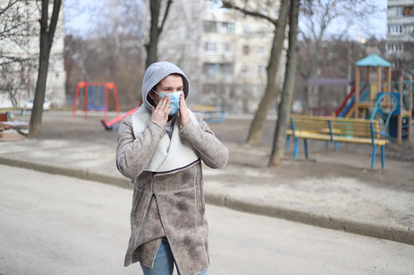 Woman wearing a face mask outdoors in cold weather