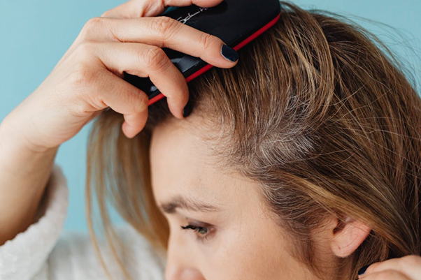 Close-up of a woman brushing her hair