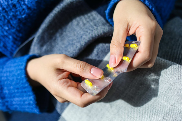 Person holding a blister pack of tablets