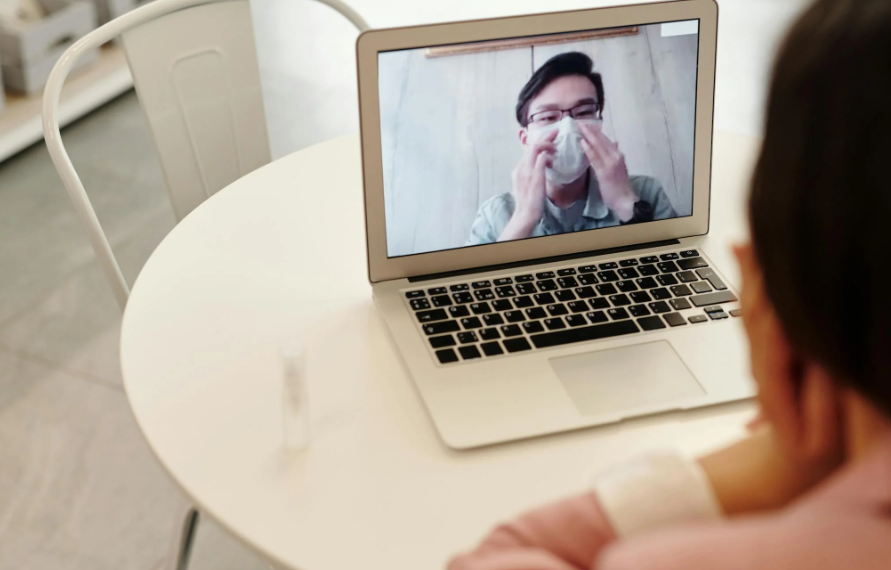 This image shows a doctor in a video call with a covid 19 patient.