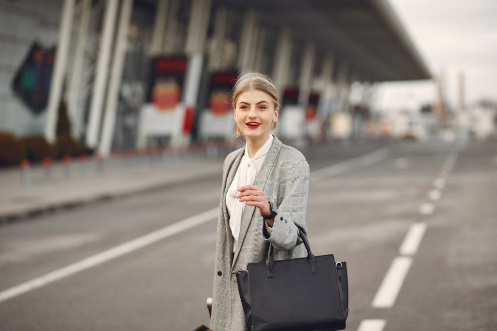 A woman standing with her purse in her hand.