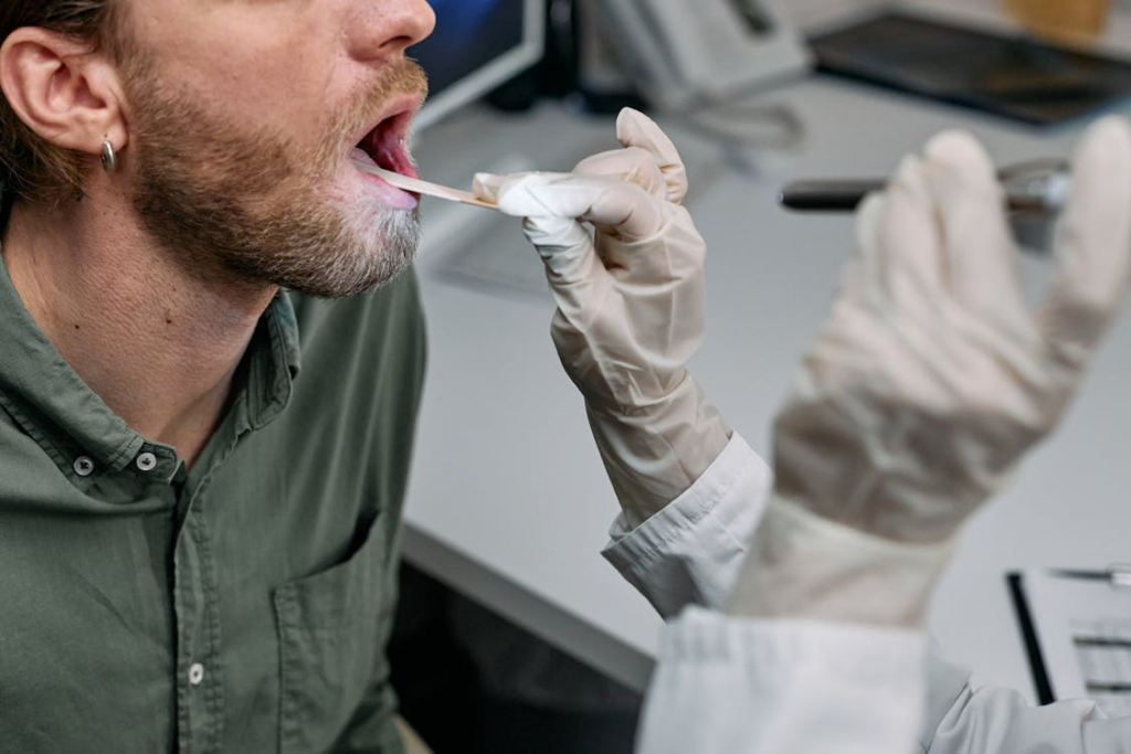 a person getting their throat checked. 