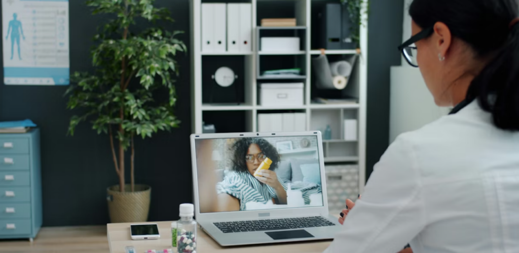 This image shows a virtual doctor for bronchitis consulting a patient via video call on a laptop.