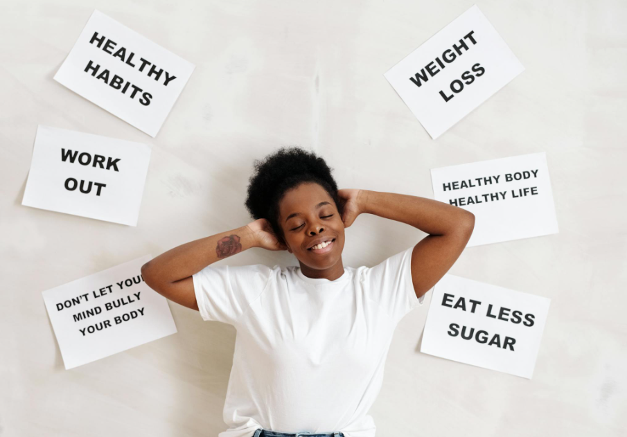 This image shows a woman lying on the floor with a few healthy habits signs.